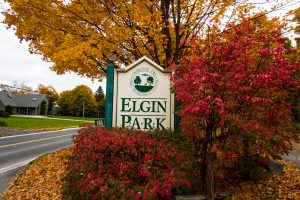 Sign for Elgin Park with red and orange autumn colours